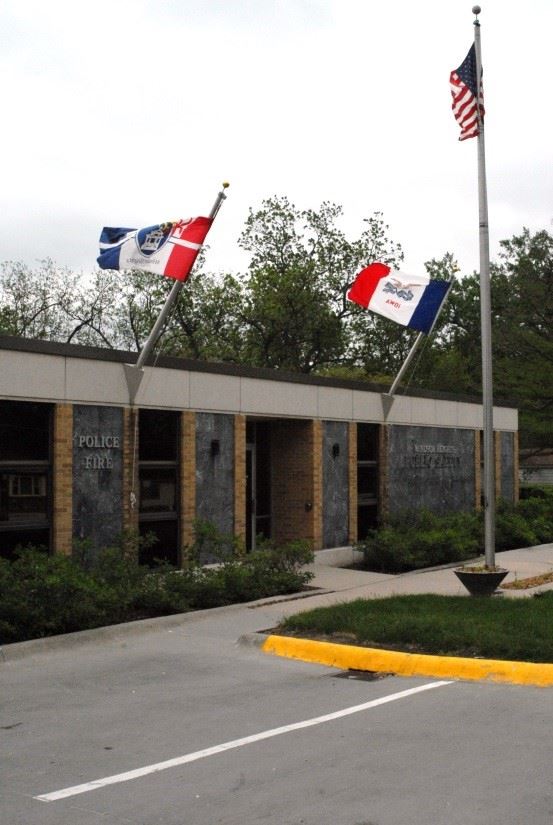 Exterior picture of Police Department building with flags
